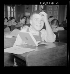 Boy at Desk Smiling Photograph
